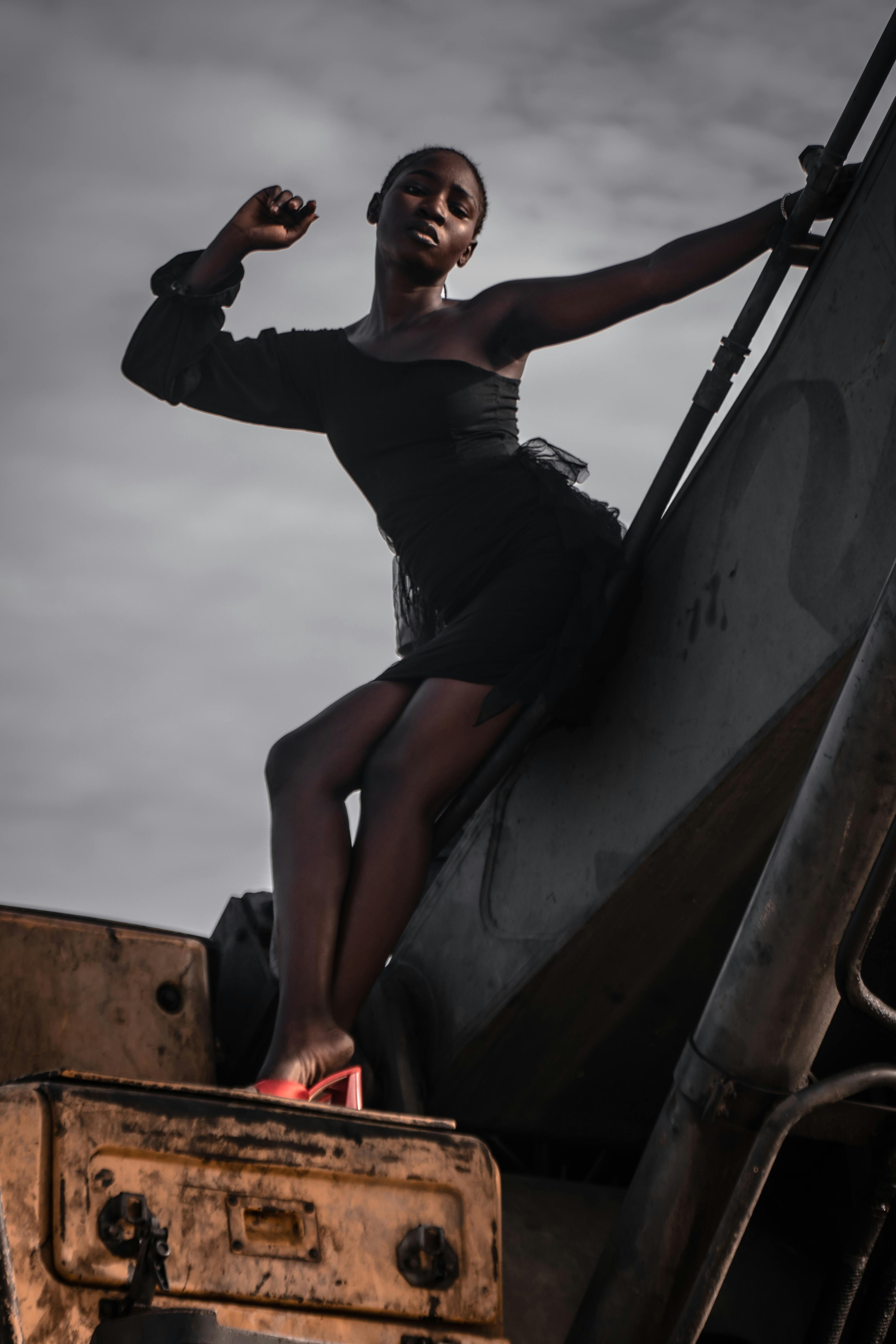 Model in a Dress Posing on an Excavator · Free Stock Photo