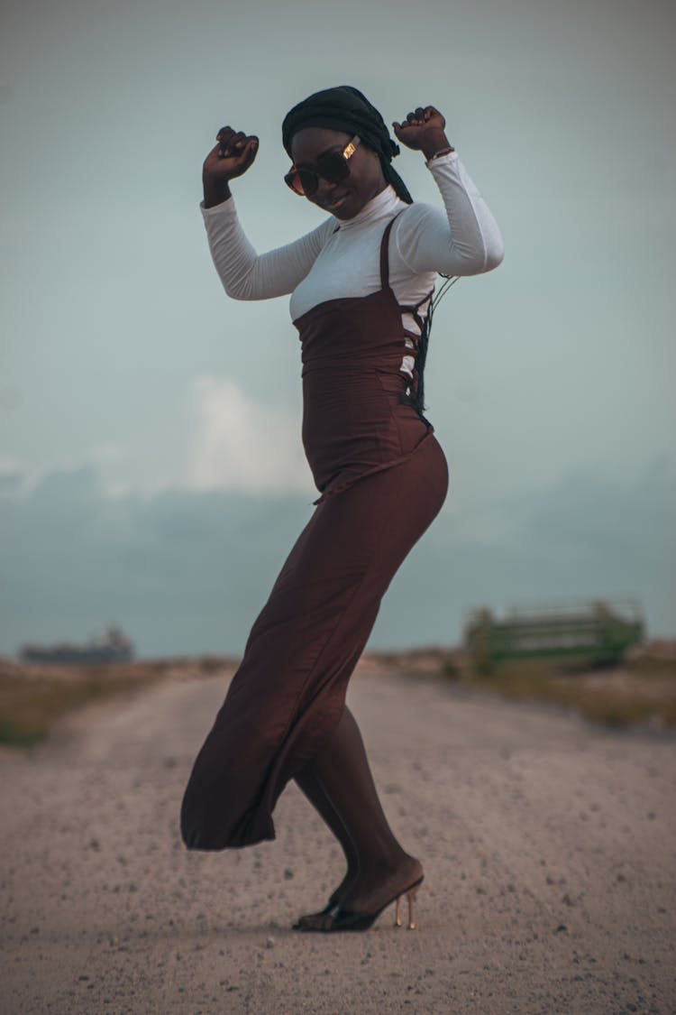 Woman Dancing On A Dirt Road