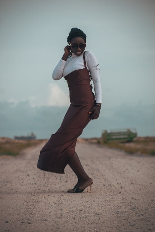 A Model in a Brown Pencil Dress on a Road