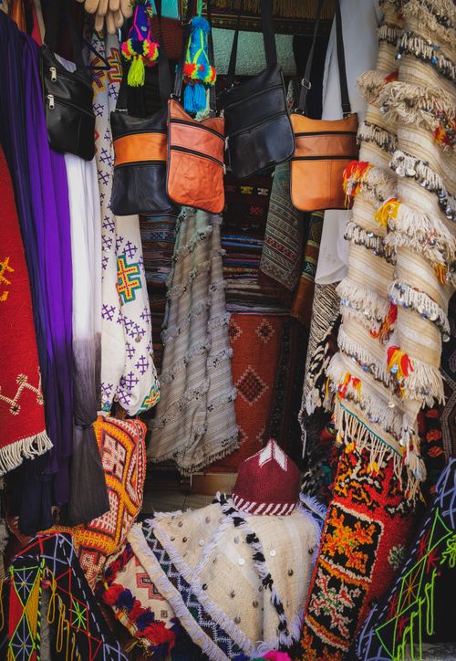 Free Vibrant display of handmade bags and tapestries at a lively street market stall. Stock Photo