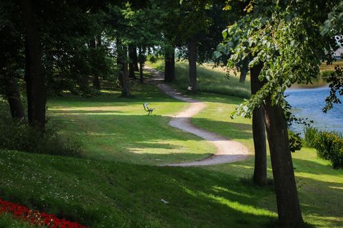 Free Serene footpath winding through a vibrant green park in Elburg, Gelderland, Netherlands. Stock Photo