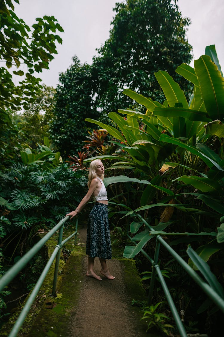 Blonde Woman In Skirt Relaxing In Garden