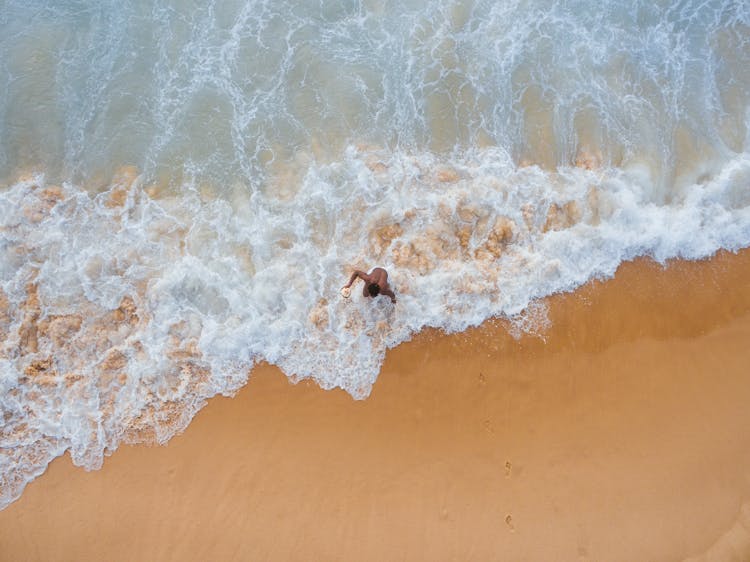 Person Walking On Shore