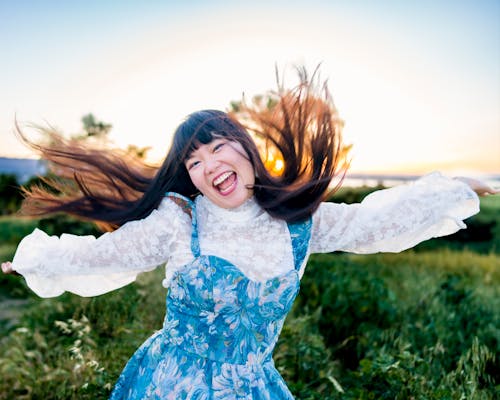 Portraita of Laughing Woman in Dress at Sunset