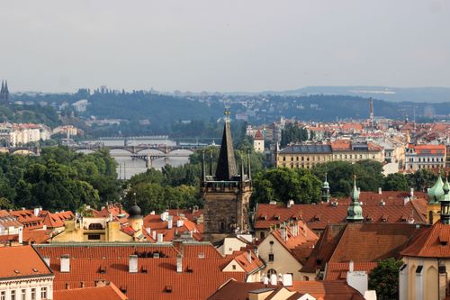 Free A scenic view of Prague's historic rooftops with the Vltava River in the background, capturing the essence of the city. Stock Photo