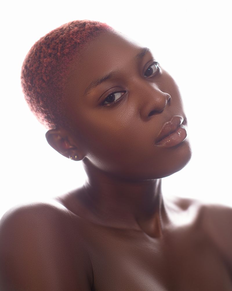 High-key portrait of a guest's precision crop with soft copper makeup