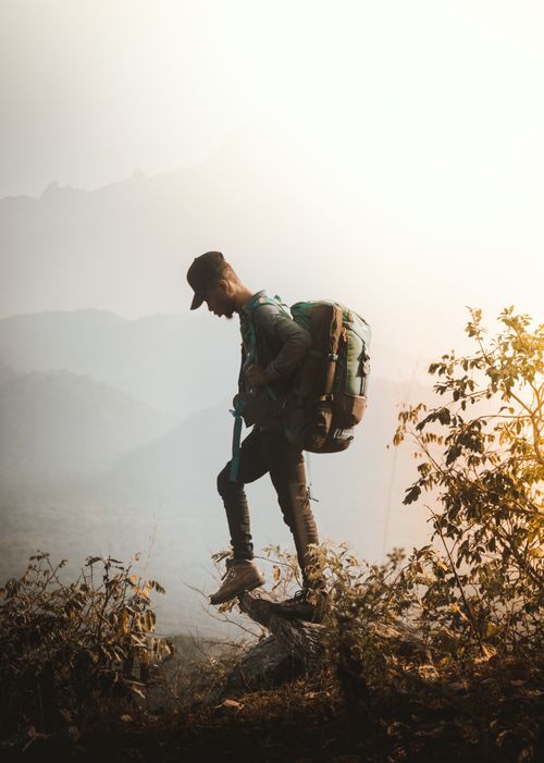 Free A hiker explores the misty landscapes of Jebba, Nigeria at sunrise. Stock Photo