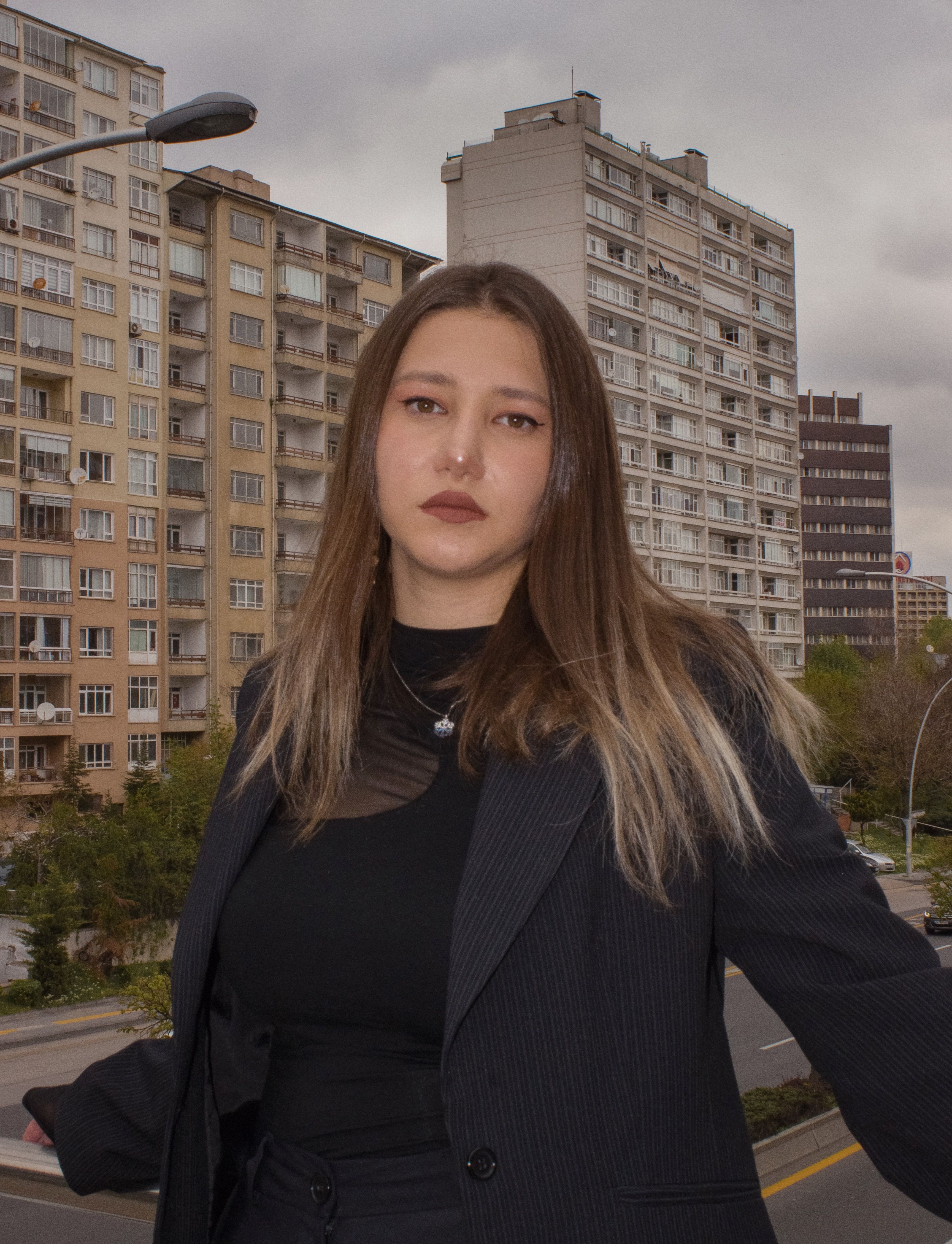A woman in a black suit standing on a street · Free Stock Photo
