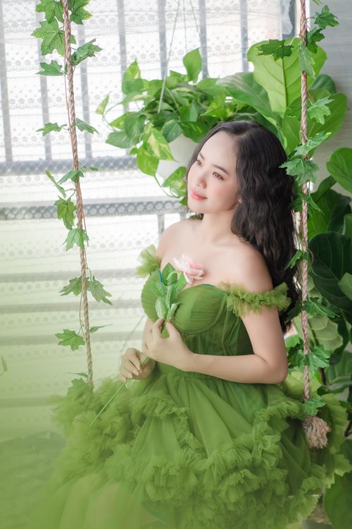 Young Woman in a Green Dress Sitting on a Swing with Flowers Free Stock Photo Young Woman in a Green Dress Sitting on a Swing with Flowers Free Stock Photo