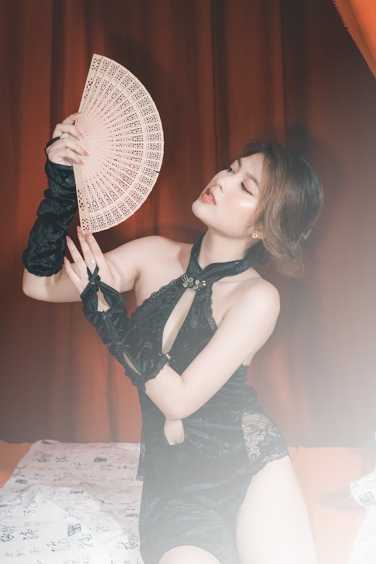 Woman In Black Clothes Posing With Fan