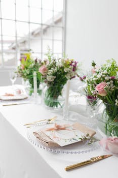 Beautifully decorated wedding table setting with elegant floral arrangements and pastel touches.