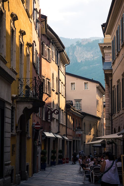 People Sitting Between Buildings