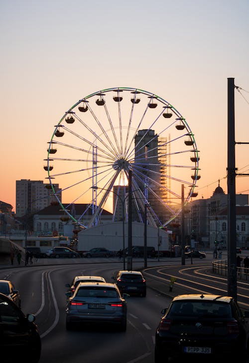 A ferris wheel in the distance at sunset