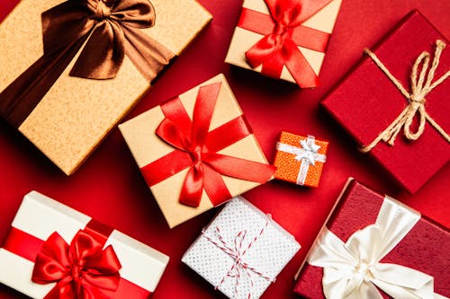 Kostenlos Verschiedene Geschenkboxen Auf Roter Oberfläche Stock-Foto