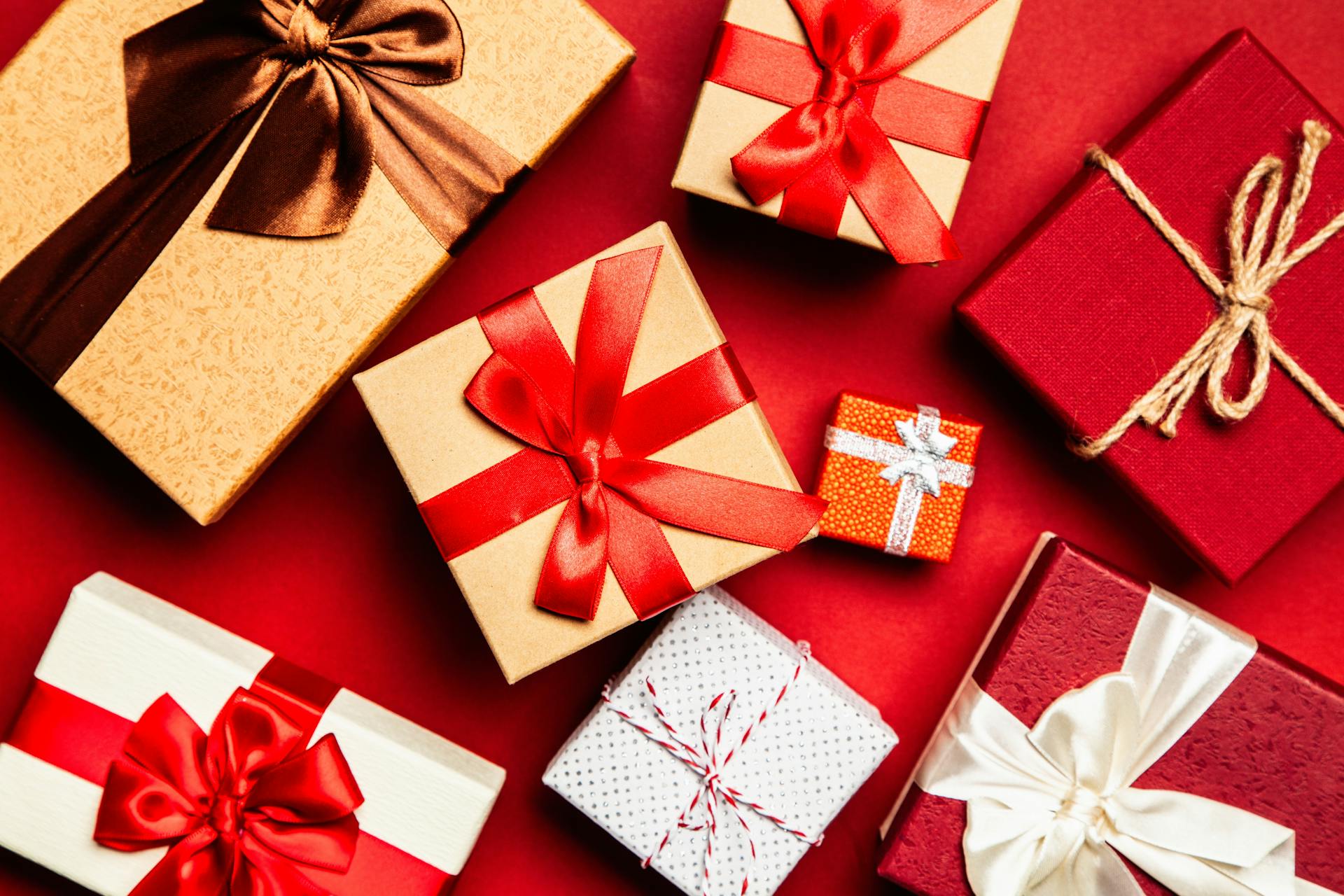 Assorted Gift Boxes on Red Surface