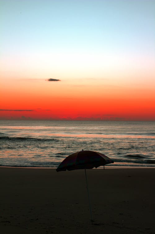 Silhouetted Umbrella on the Beach at Sunset 