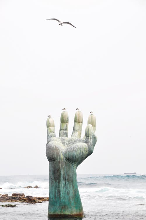 Statue of a Human Hand in the Sea 