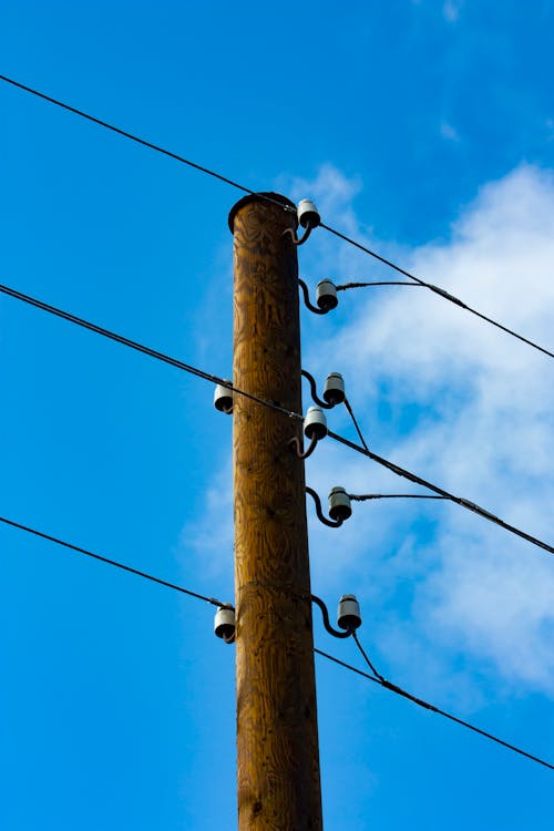 Low Angle Shoot of a Utility Pole on the Background of Blue Sky 