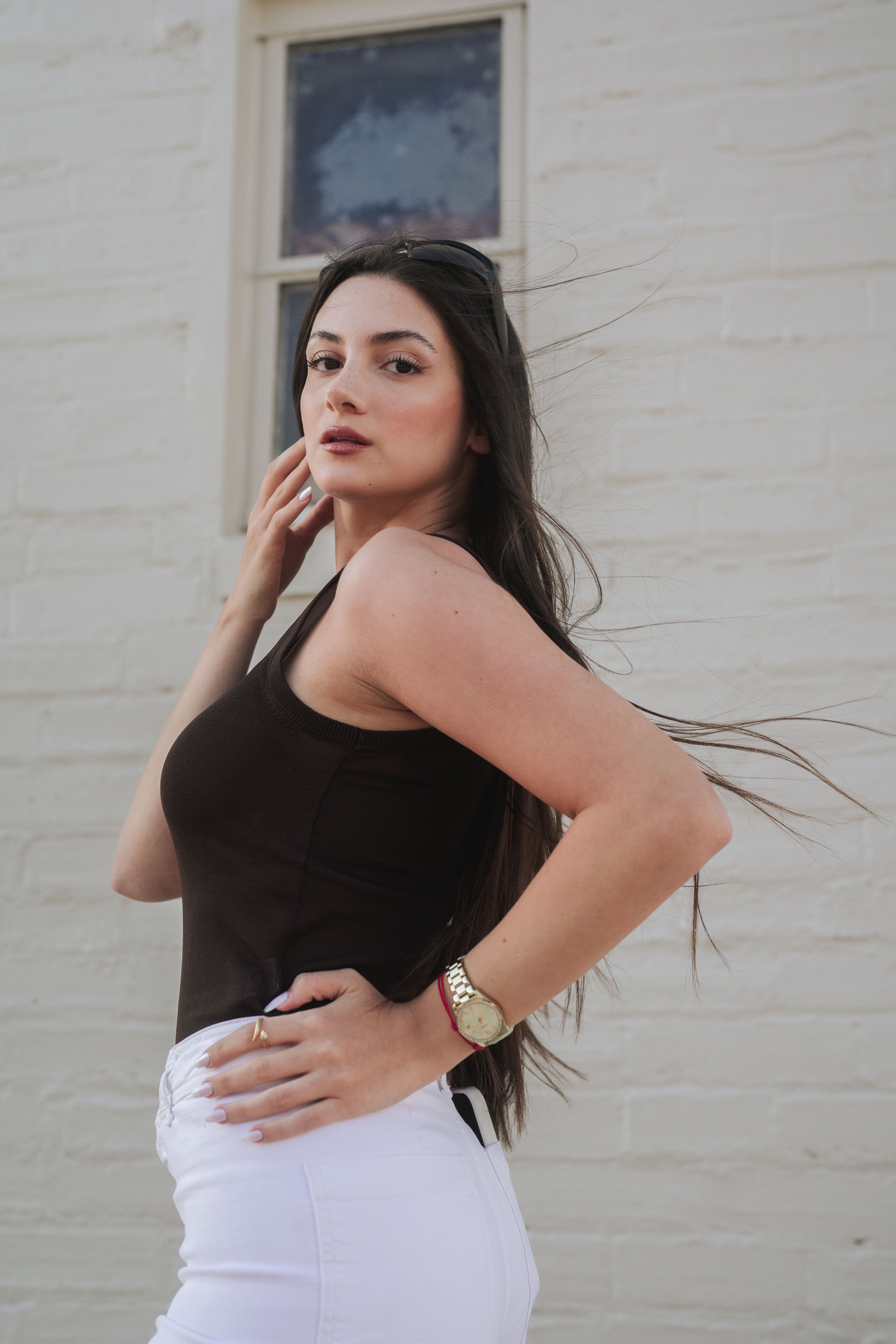Woman Posing in Black Tank Top and White Jeans · Free Stock Photo