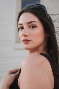 Portrait of a young brunette woman outdoors, exuding a casual summer vibe.