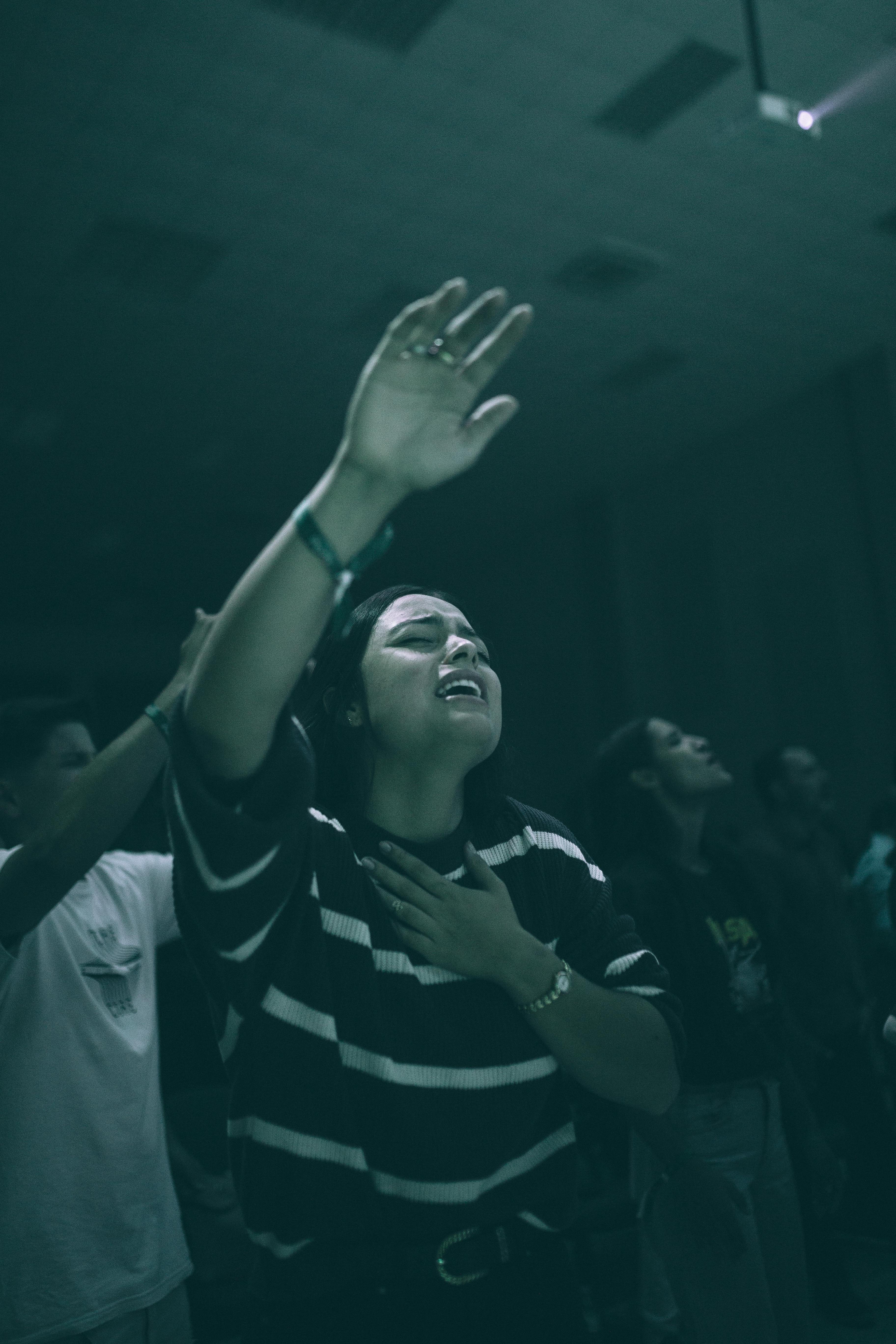 Young Woman in the Crowd Singing with Eyes Closed · Free Stock Photo