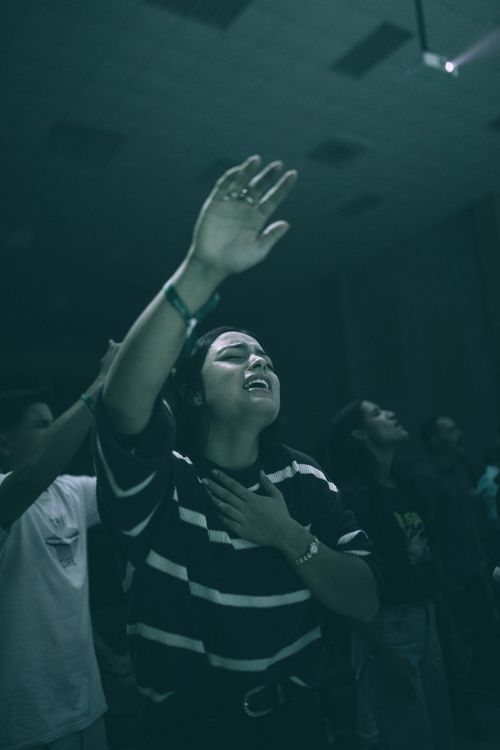 Free A group of young adults immersed in an emotional spiritual worship experience. Stock Photo