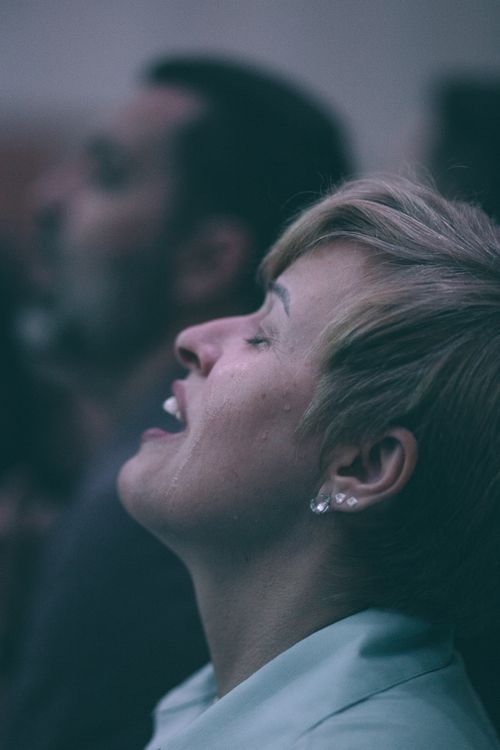 Free A woman deeply engrossed in prayer with eyes closed, exuding serenity and devotion. Stock Photo