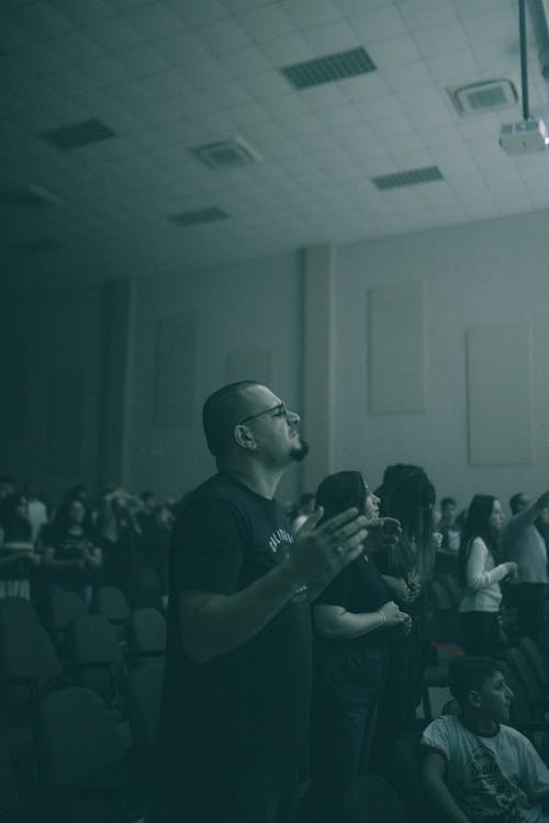 People Standing with Eyes Closed in the Audience 