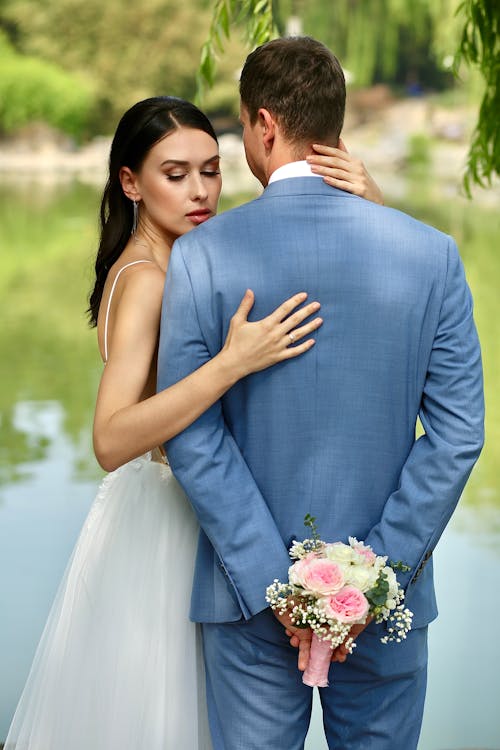 Newlywed Couple Posing by the Lake