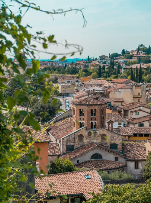 Free A picturesque view of Verona's medieval architecture with lush greenery in summer. Stock Photo