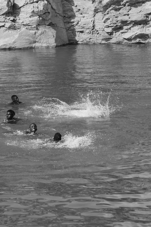 People Playing in Water in Black and White