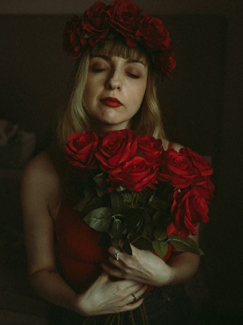 Woman Posing with Red Flowers