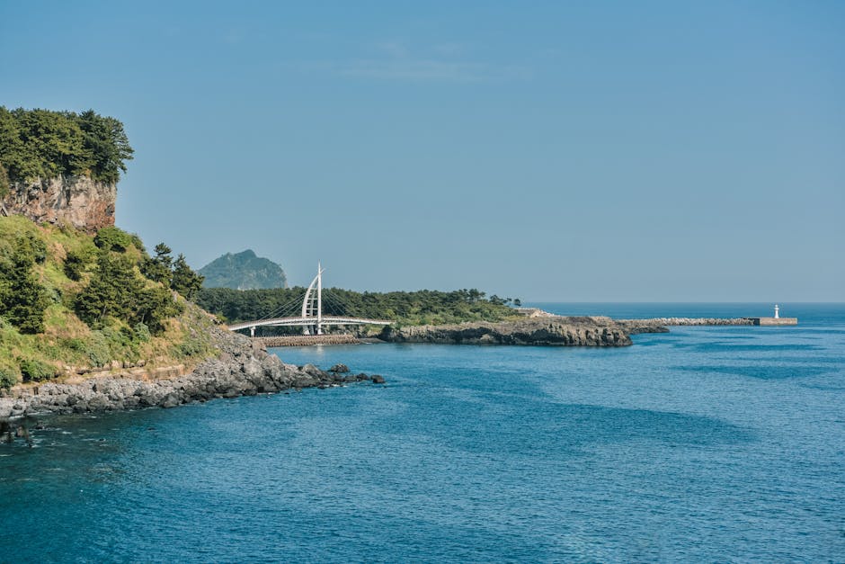 A breathtaking coastal view of Jeju Island with clear blue waters and scenic cliffs. in South Korea