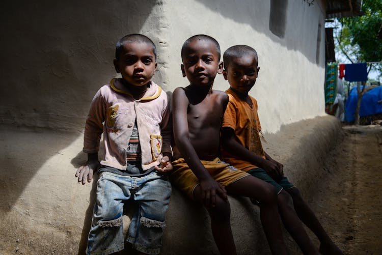 Children Posing By House Corner