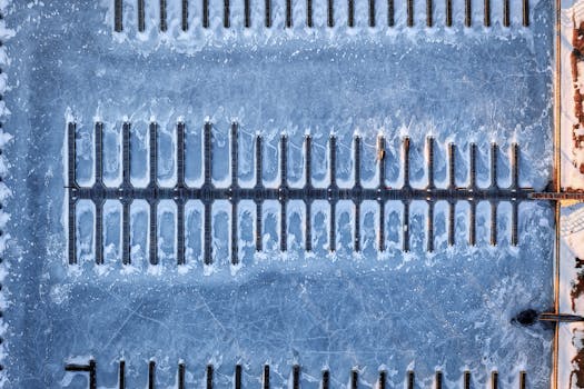 Top-down view of a frozen marina in Lake City, Minnesota showcasing icy patterns and empty docks.