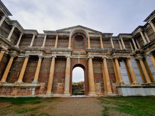 Free Stunning ancient Roman temple facade with brick and columns under a blue sky. Stock Photo