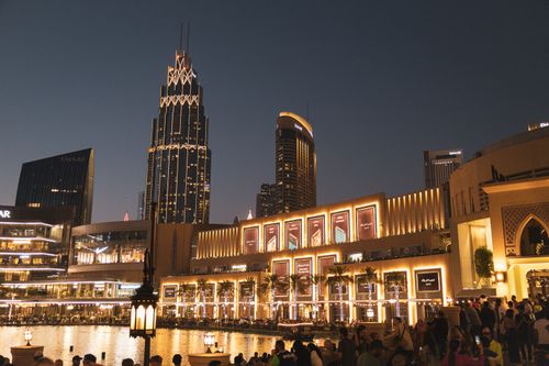 Free Illuminated skyscrapers and bustling cityscape of Downtown Dubai at night, capturing the vibrant urban life. Stock Photo