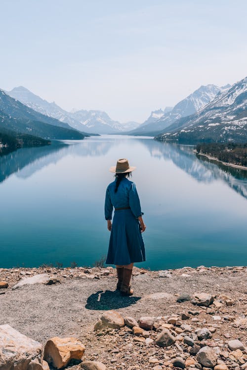 Woman Posing by Lake in Mountains
