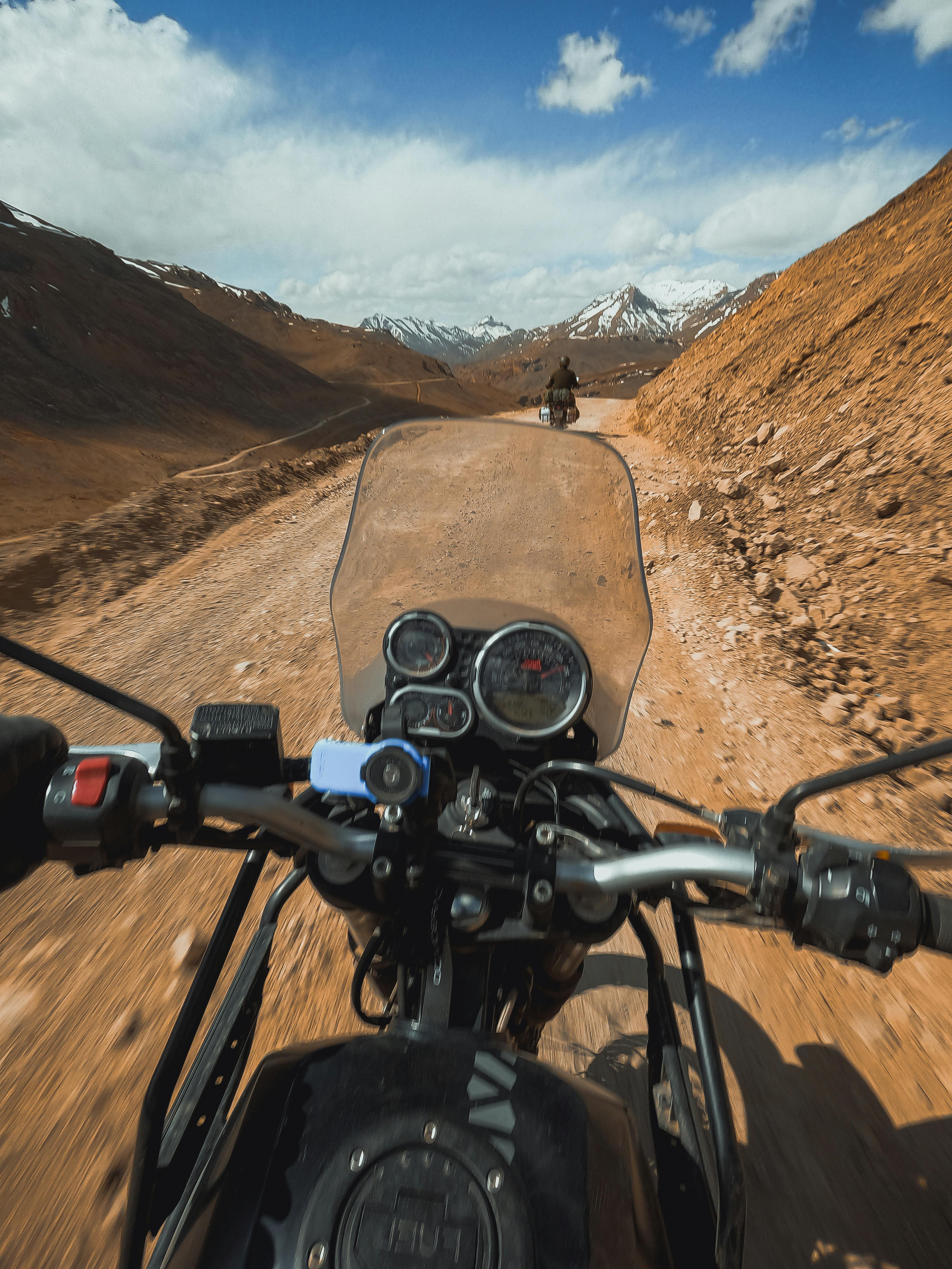 riding motorbike on dirt road in mountains