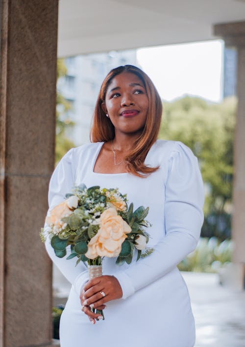 Bride Holding Bouquet of Cream Roses