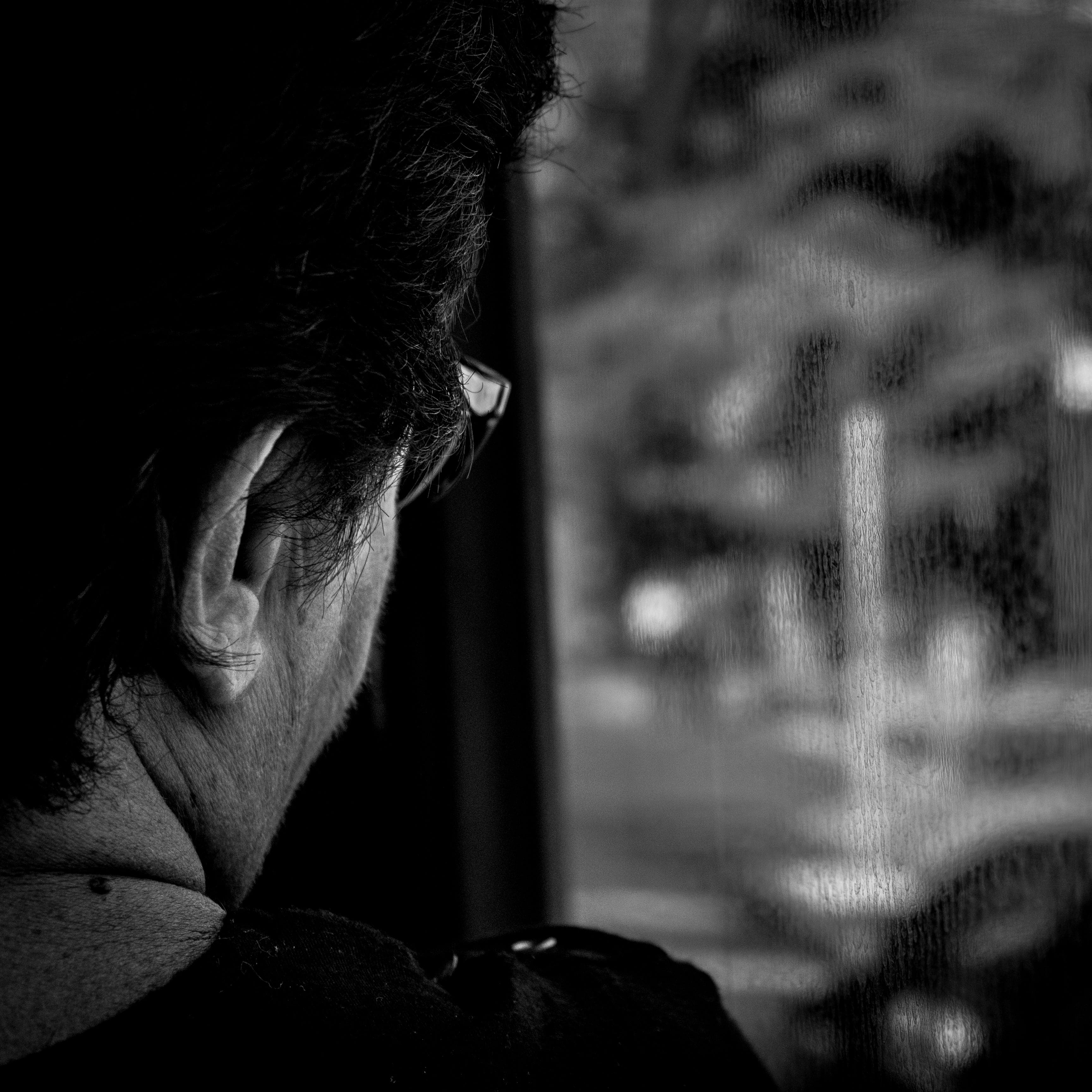 a man looking out the window of a bus