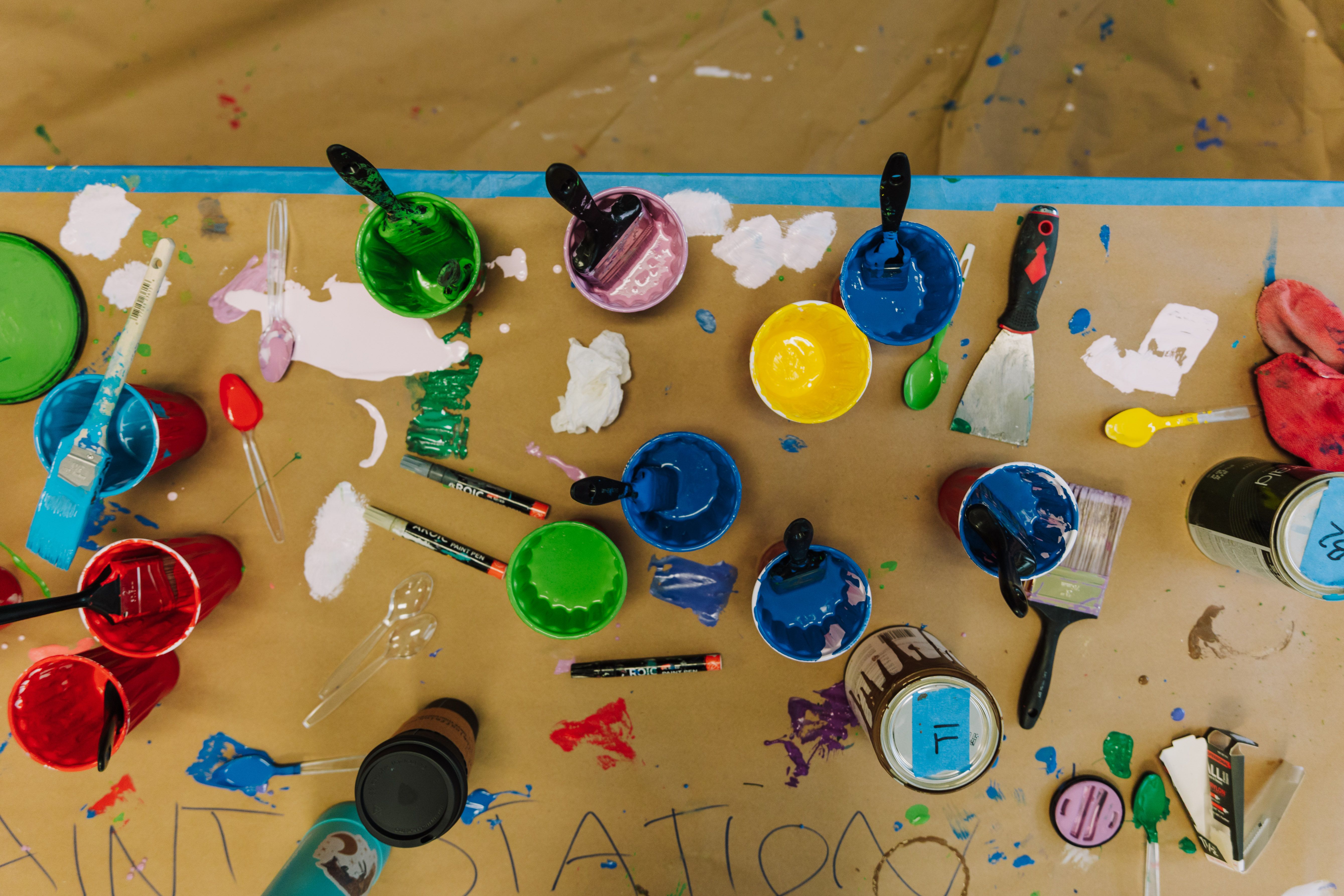 Top view of colorful art supplies on a table, showcasing creativity and artistic expression.