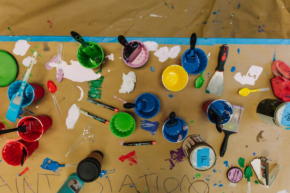 Top view of colorful art supplies on a table, showcasing creativity and artistic expression.