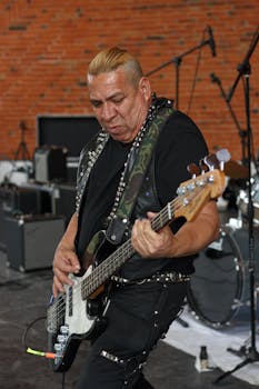 A skilled musician passionately playing a guitar during a live performance indoors.