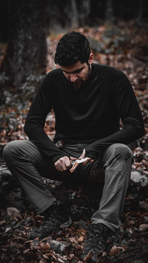 Man Making a Fire in a Forest 