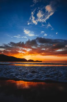 Breathtaking view of a sunset over the ocean with vibrant colors and scenic clouds.