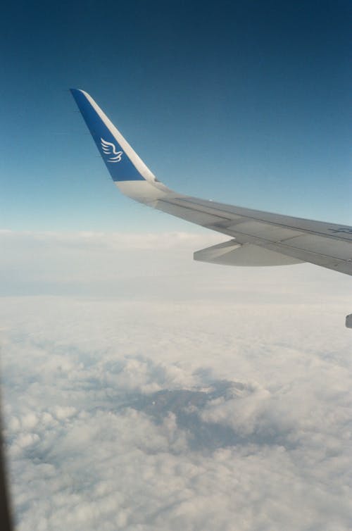 Aerial Photograph of Clouds and a Wing of an Airplane