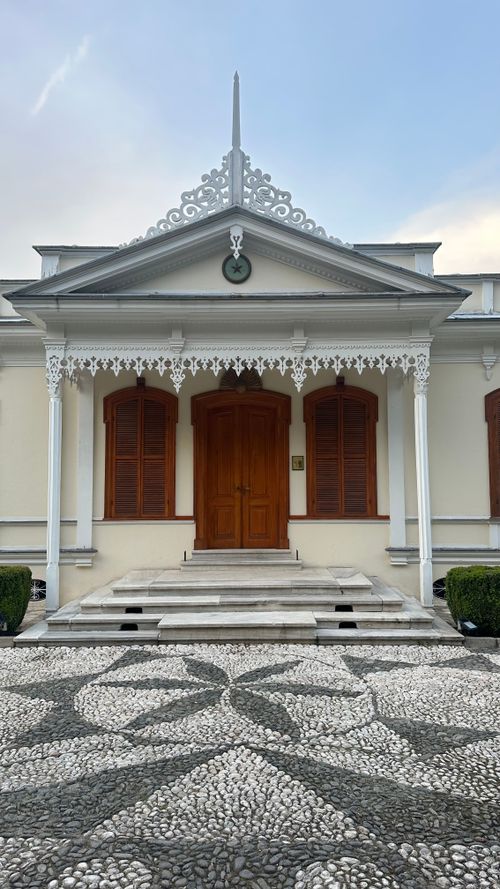 Free Classic facade with ornate decor and wooden door, featuring decorative columns. Stock Photo