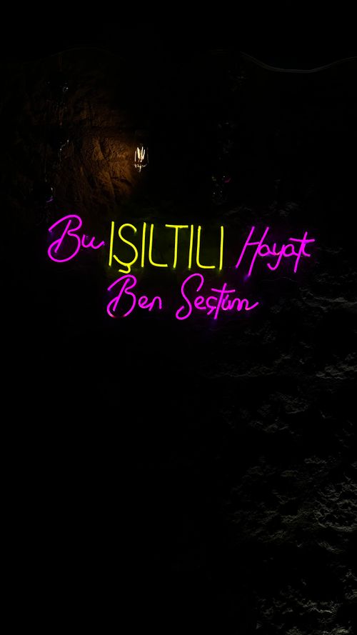 Free Colorful neon text display in a dark setting, ideal for background use. Stock Photo