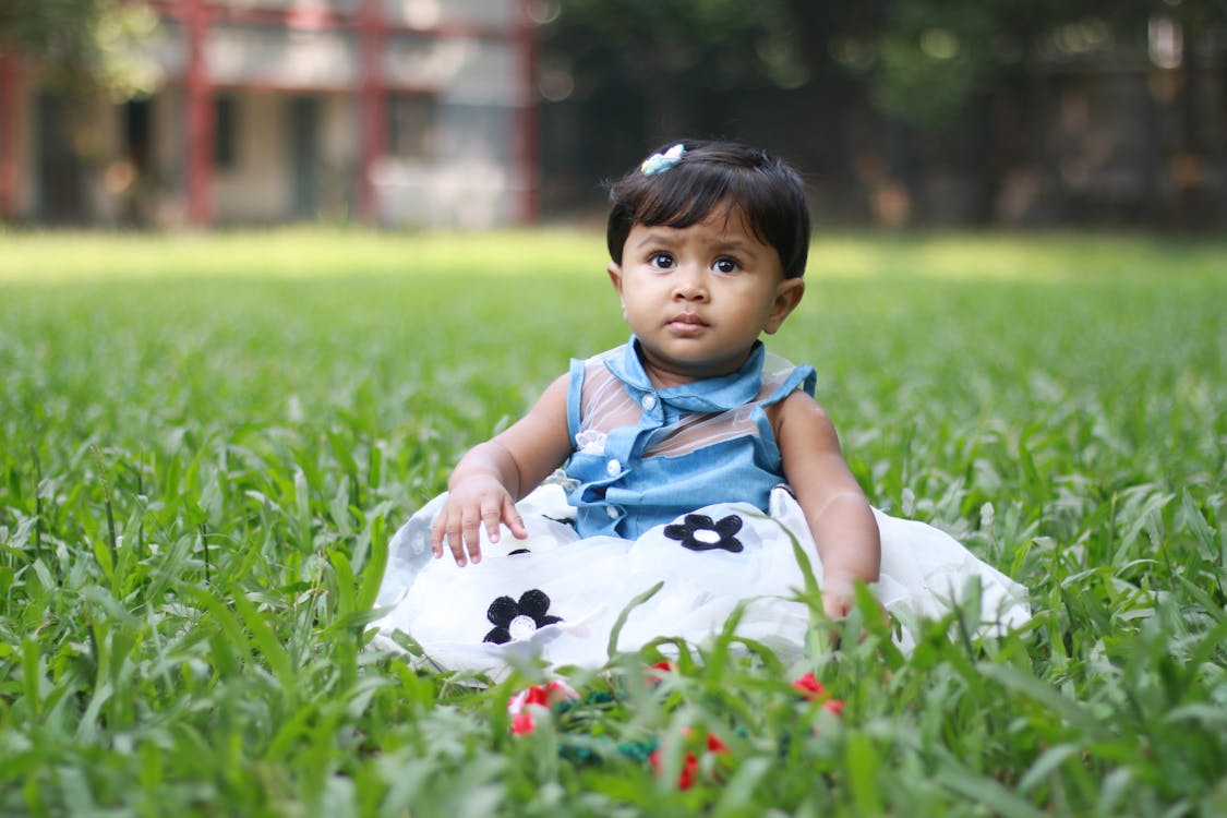 Photo of Baby Sitting On Grass